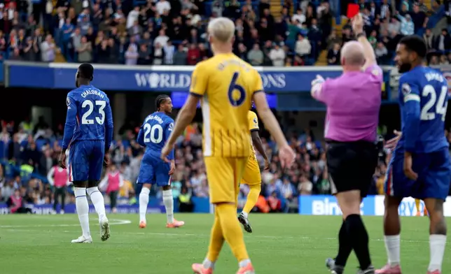 Chelsea's Trevoh Chalobah, left, is given a red card during the English Premier League soccer match between Chelsea and Brighton &amp; Hove Albion at Stamford Bridge, London, Saturday Sept. 27, 2025. (Steven Paston/PA via AP)