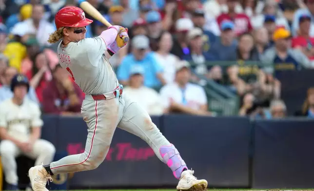Philadelphia Phillies' Harrison Bader hits an RBI double, allowing Brandon Marsh to score, during the eighth inning of a baseball game against the Milwaukee Brewers, Monday, Sept. 1, 2025, in Milwaukee. (AP Photo/Kayla Wolf)