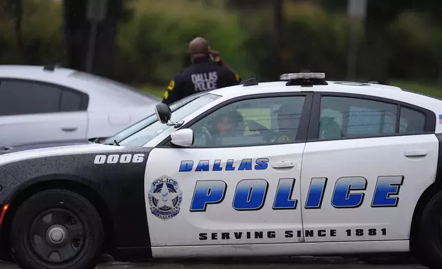 Police block off the street close to a U.S. Immigration and Customs Enforcement office after a reported shooting, in Dallas on Wednesday, Sept. 24, 2025. (AP Photo/Julio Cortez)