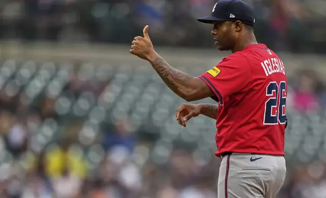 Atlanta Braves relief pitcher Raisel Iglesias gestures during the ninth inning of a baseball game against the Detroit Tigers, Sunday, Sept. 21, 2025, in Detroit. (AP Photo/Ryan Sun)
