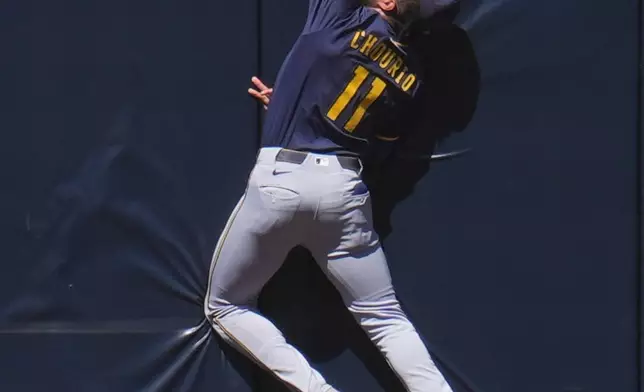 Milwaukee Brewers center fielder Jackson Chourio makes the catch at the wall for the out on San Diego Padres' Jake Cronenworth during the second inning of a baseball game Wednesday, Sept. 24, 2025, in San Diego. (AP Photo/Gregory Bull)