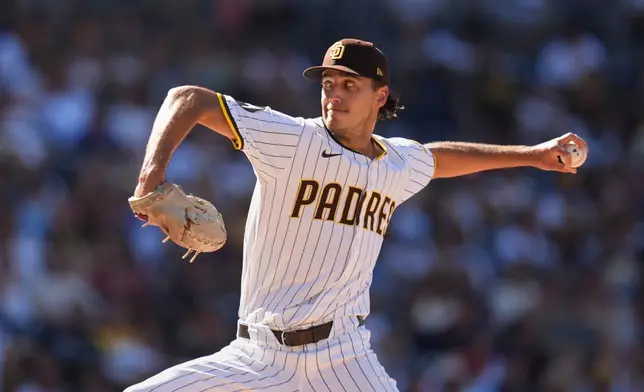 San Diego Padres relief pitcher Kyle Hart works against a Milwaukee Brewers batter during the eighth inning of a baseball game Wednesday, Sept. 24, 2025, in San Diego. (AP Photo/Gregory Bull)