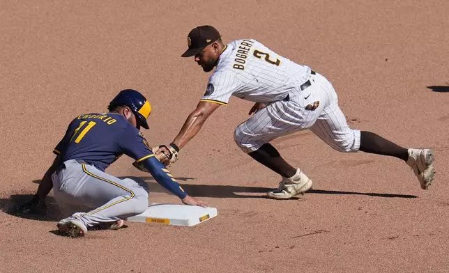 Milwaukee Brewers' Jackson Chourio, left, safely steals second base as San Diego Padres shortstop Xander Bogaerts (2) is late with the tag during the seventh inning of a baseball game Wednesday, Sept. 24, 2025, in San Diego. (AP Photo/Gregory Bull)