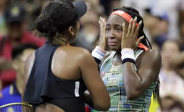FILE - Coco Gauff wipes away tears while talking to Naomi Osaka, of Japan, after Osaka defeated Gauff during the third round of the U.S. Open tennis tournament Saturday, Aug. 31, 2019, in New York. (AP Photo/Adam Hunger, File)