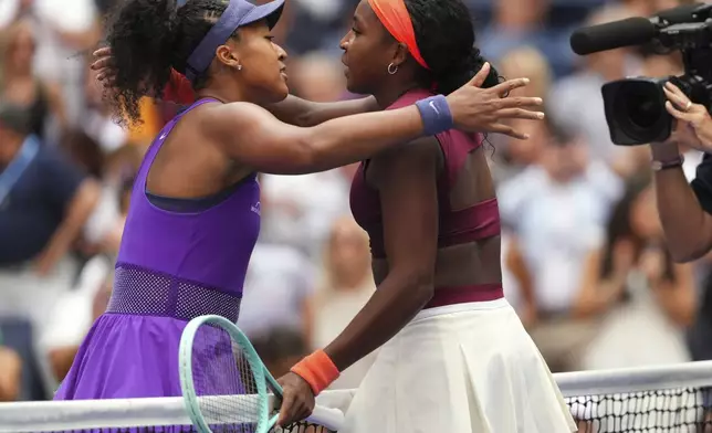 Naomi Osaka, left, of Japan, greets Coco Gauff, of the United States, after their match in the fourth round of the US Open tennis championships, Monday, Sept. 1, 2025, in New York. (AP Photo/Kirsty Wigglesworth)