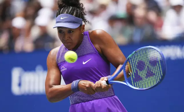 Naomi Osaka, of Japan, returns a shot against Coco Gauff, of the United States, during the fourth round of the US Open tennis championships, Monday, Sept. 1, 2025, in New York. (AP Photo/Kirsty Wigglesworth)
