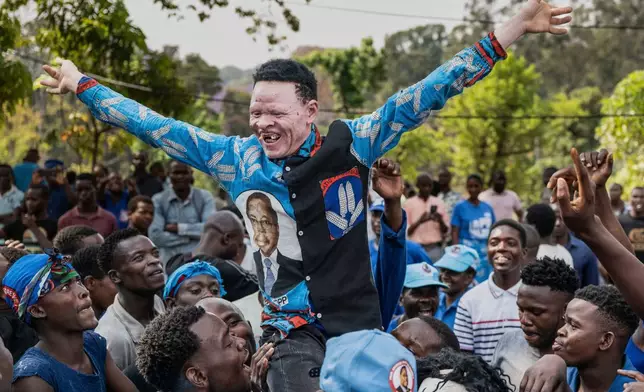 Supporters of former President Peter Mutharika celebrate after his opponent concedes election to Mutharika, in Blantyre, Malawi, Wednesday, Sept. 24, 2025. (AP Photo/Thoko Chikondi)