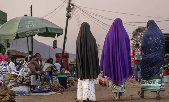 Women walk at a market in Blantyre, Malawi, Tuesday, Sept. 16, 2025. (AP Photo/Thoko Chikondi)