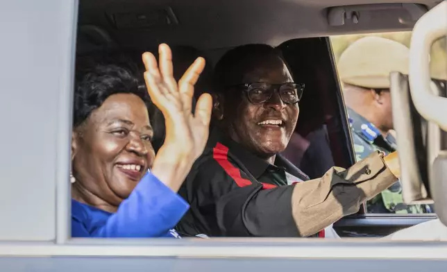 Malawi President Lazarus Chakwera, right, and his wife wave during a campaign rally in Blantyre, Malawi, Sunday, Sept. 7, 2025. (AP Photo/Thoko Chikondi)