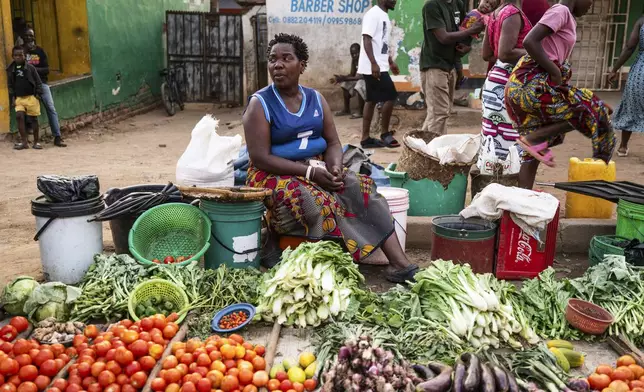 A woman sells vegetables in Blantyre, Malawi, Tuesday, Sept. 16, 2025. (AP Photo/Thoko Chikondi)