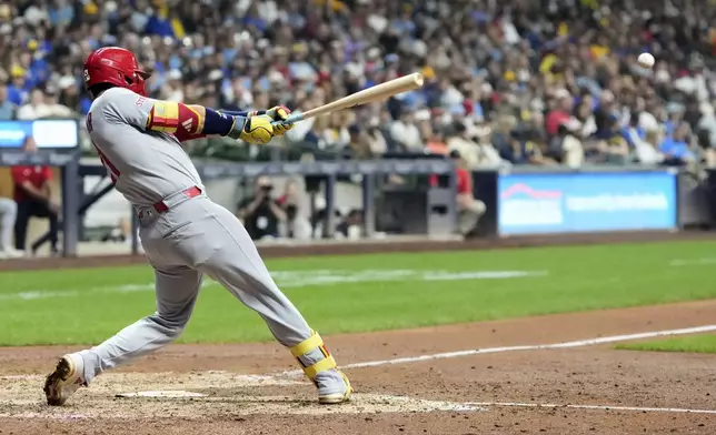 St. Louis Cardinals' Lars Nootbaar hits an RBI single during the sixth inning of a baseball game against the Milwaukee Brewers Friday, Sept. 12, 2025, in Milwaukee. (AP Photo/Morry Gash)