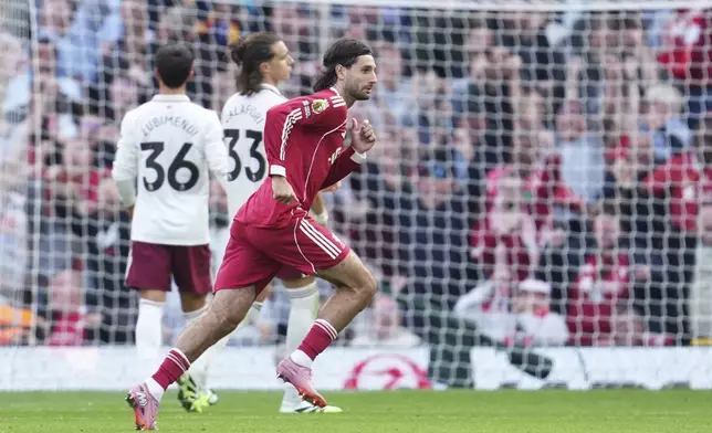 Liverpool's Dominik Szoboszlai runs to celebrate after scoring his sides first goal during the English Premier League soccer match between FC Liverpool and FC Arsenal in Liverpool, England, Sunday, Aug. 31, 2025. (AP Photo/Jon Super)