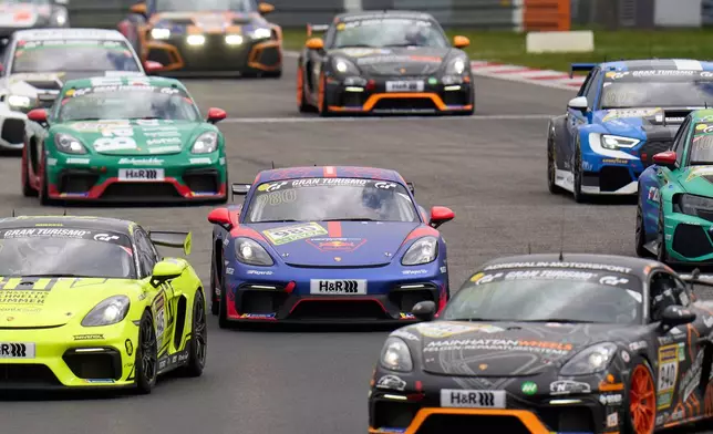 Four-time Formula 1 world champion Max Verstappen, centre, takes part in the 1000km race at the Nürburgring in a Porsche Cayman (no. 980), in Nürburg, Germany, Saturday Sept. 13, 2025. (Thomas Frey/dpa via AP)