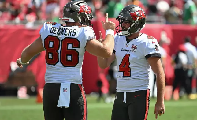 Tampa Bay Buccaneers kicker Chase McLaughlin (4) celebrates with long snapper Evan Deckers (86) after kicking a field goal during the first half of an NFL football game against the Philadelphia Eagles, Sunday, Sept. 28, 2025, in Tampa, Fla. (AP Photo/Jason Behnken)