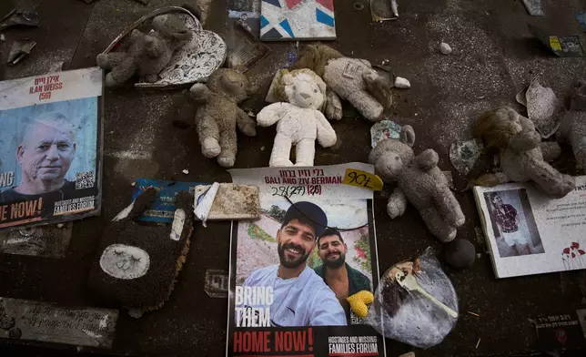 Photos of twin brothers Gali and Ziv Berman, center, who have been held hostage in Gaza since the Hamas cross-border attack on Israel on Oct. 7, 2023, are displayed at a memorial in Tel Aviv, Israel, Thursday, Sept. 25, 2025. (AP Photo/Oded Balilty)