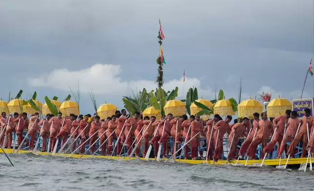 Intha ethnic people row on a long boat in a procession carrying Buddha images to a monastery during the Phaung Daw Oo pagoda festival Friday, Sept. 26, 2025, in Inle Lake, southern Shan State, Myanmar. (AP Photo/Thein Zaw)