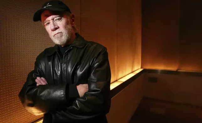 FILE - Actor and comedian George Carlin poses in a New York hotel March 19, 2004. (AP Photo/Gregory Bull, File)