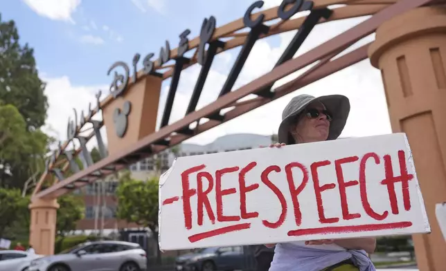 A demonstrator holds a sign in response to the suspension of Jimmy Kimmel's late-night show outside of Walt Disney Studios in Burbank, Calif., on Thursday, Sept. 18, 2025. (AP Photo/Jae C. Hong)