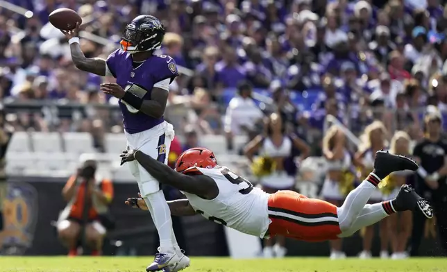Baltimore Ravens quarterback Lamar Jackson throws under pressure from Cleveland Browns defensive tackle Maliek Collins during the second half of an NFL football game, Sunday, Sept. 14, 2025, in Baltimore. (AP Photo/Stephanie Scarbrough)
