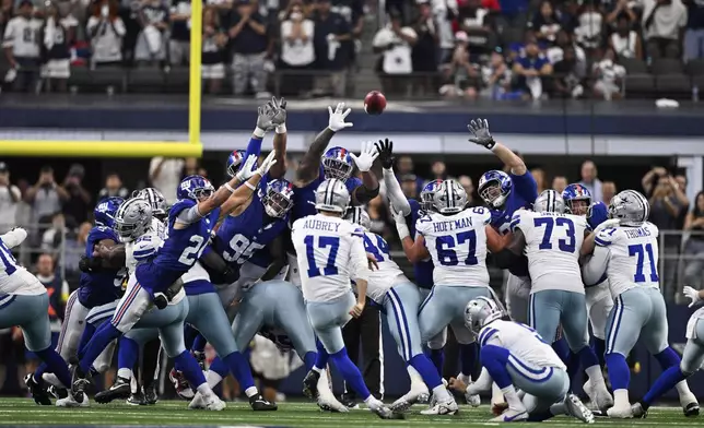 Dallas Cowboys place kicker Brandon Aubrey (17) kicks a game-winning field goal against the New York Giants in overtime of an NFL football game Sunday, Sept. 14, 2025, in Arlington, Texas. (AP Photo/Jerome Miron)