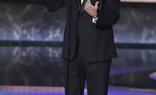 Stephen Colbert presents the award for outstanding lead actor in a comedy series during the 77th Primetime Emmy Awards on Sunday, Sept. 14, 2025, at the Peacock Theater in Los Angeles. (AP Photo/Chris Pizzello)