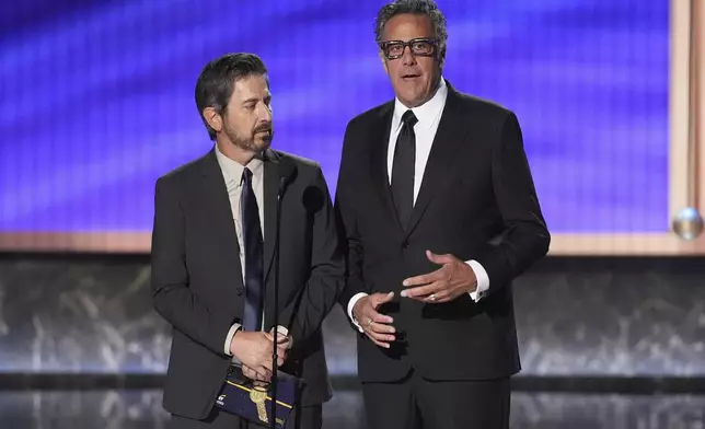 Ray Romano, left, and Brad Garrett present the award for outstanding comedy series during the 77th Primetime Emmy Awards on Sunday, Sept. 14, 2025, at the Peacock Theater in Los Angeles. (AP Photo/Chris Pizzello)