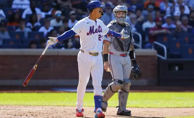 New York Mets' Mark Vientos reacts after being hit by a pitch from Miami Marlins' Sandy Alcantara during the seventh inning of a baseball game, Sunday, Aug. 31, 2025, in New York. (AP Photo/Noah K. Murray)