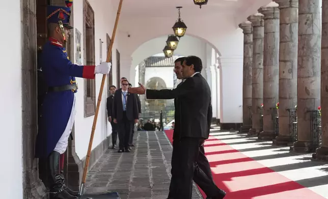 A protocol officer shows the way to U.S. Secretary of State Marco Rubio as he arrives to meet with Ecuador's President Daniel Noboa at the presidential palace in Quito, Ecuador, Thursday, Sep. 4, 2025. (AP Photo/Jacquelyn Martin, pool)