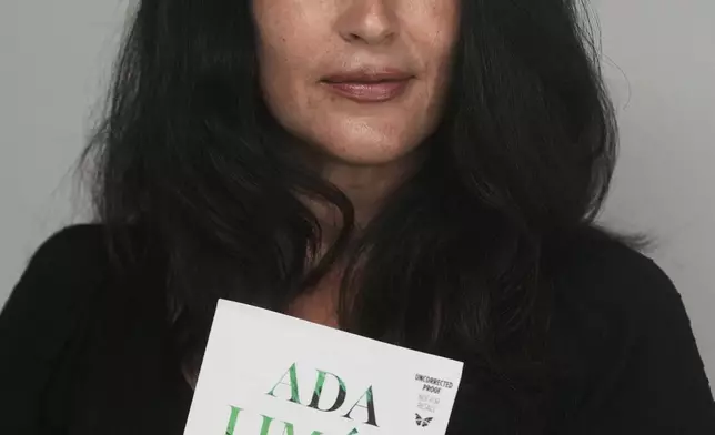 Ada Limón, 24th Poet Laureate of the United States, poses with a copy of her book "Startlement" in Sonoma County, Calif., on Friday, Aug. 22, 2025. (AP Photo/Jeff Chiu)