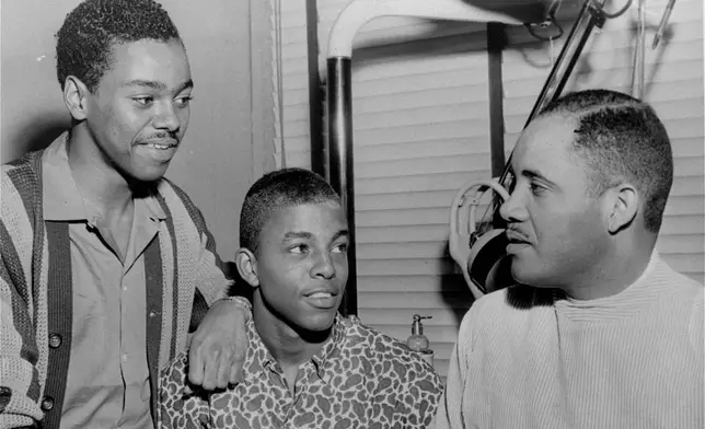 FILE - Joseph McNeil, left, stands next to Ezell Blair, Jr., center, student leader in the original lunch counter sit-down demonstration, discussed legal aspects of anti-segregation with Dr. George C. Simkins, right, Greensboro dentist and local NAACP leader, in Greensboro, N.C., April 20, 1960. (News &amp; Record via AP, File)