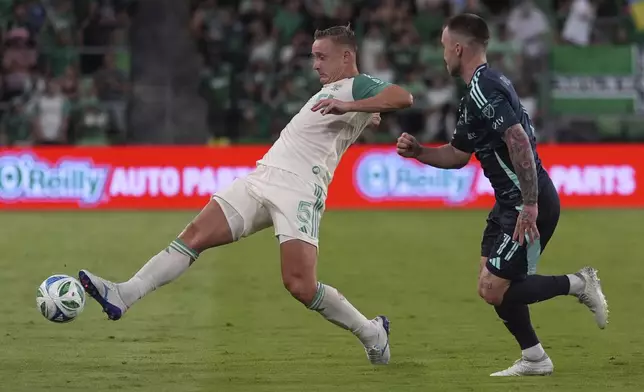 Austin FC defender Marius Hoibraten (5) moves the ball past Seattle Sounders' Albert Rusnak (11) during the second half of an MLS soccer match in Austin, Texas, Sunday, Sept. 21, 2025. (AP Photo/Eric Gay)