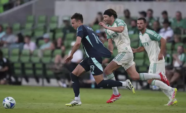 Austin FC midfielder Taishi Matsumoto, center, pulls Seattle Sounders usa Danny Musovski (19) away from the ball during the second half of an MLS soccer match in Austin, Texas, Sunday, Sept. 21, 2025. (AP Photo/Eric Gay)