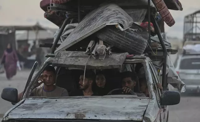 Displaced Palestinians fleeing northern Gaza Strip move with their belongings along the Sea Road, in Gaza City, Monday, Sept. 1, 2025. (AP Photo/Jehad Alshrafi)