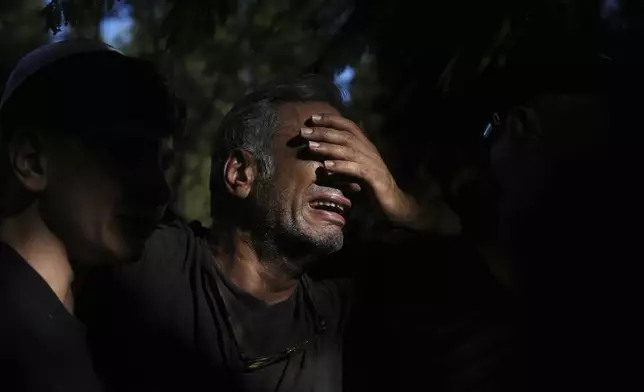 A relative mourns during the funeral of slain hostage Idan Shtivi, whose body was recovered in an Israeli military operation in the Gaza Strip, in Kfar Maas, Israel, Monday, Sept. 1, 2025. (AP Photo/Ariel Schalit)