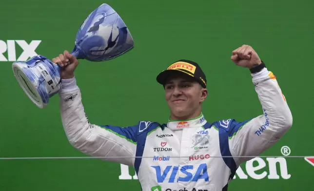 Racing Bulls driver Isack Hadjar of France celebrates his third place after the Formula One Dutch Grand Prix race at the Zandvoort racetrack in Zandvoort, Netherlands, Sunday, Aug. 31, 2025. (AP Photo/Patrick Post)