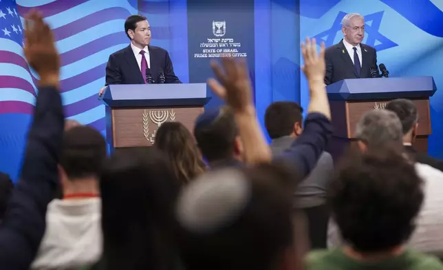 Journalists raise their hands as Israeli Prime Minister Benjamin Netanyahu, right, and U.S. Secretary of State Marco Rubio hold a joint press conference at the Prime Minister's Office, during Rubio's visit, in Jerusalem, Monday, Sept. 15, 2025. (Nathan Howard/Pool Photo via AP)