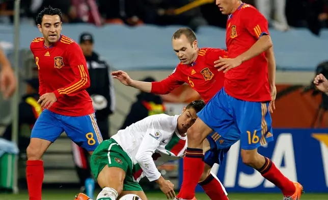 FILE - Portugal's Cristiano Ronald, bottom, tries to get the ball from Spain's Xavi Hernandez, left, Spain's Sergio Busquets, right, and Spain's Andres Iniesta, during the World Cup round of 16 soccer match between Spain and Portugal at the Green Point stadium in Cape Town, South Africa, Tuesday, June 29, 2010. (AP Photo/Armando Franca, File)
