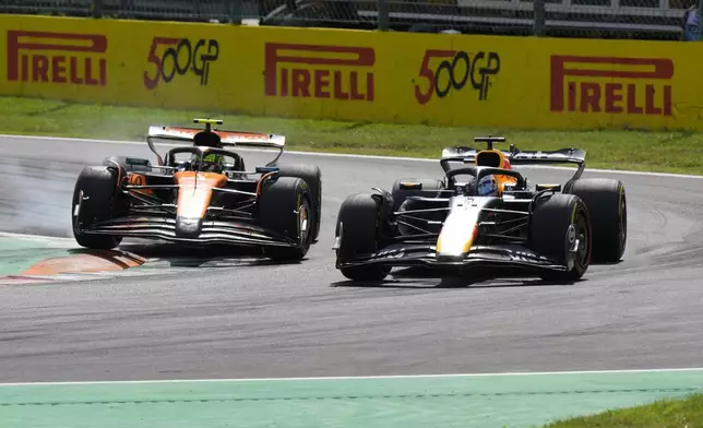 Red Bull driver Max Verstappen of the Netherlands, left, overtakes McLaren driver Lando Norris of Britain during the Italian Grand Prix race at the Monza racetrack in Monza, Italy, Sunday, Sept. 7, 2025. (AP Photo/Luca Bruno)
