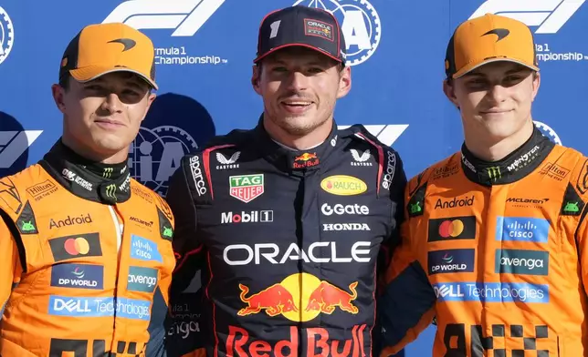 Red Bull driver Max Verstappen of the Netherlands, centre, celebrates his pole position with McLaren driver Lando Norris of Britain, left, and McLaren driver Oscar Piastri of Australia after the qualifying session ahead of the Italian Grand Prix at the Monza racetrack in Monza, Italy, Saturday, Sept. 6, 2025. (AP Photo/Luca Bruno)