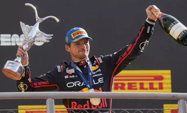 Red Bull driver Max Verstappen of the Netherlands celebrates on the podium after winning the Italian Grand Prix race at the Monza racetrack in Monza, Italy, Sunday, Sept. 7, 2025. (AP Photo/Luca Bruno)