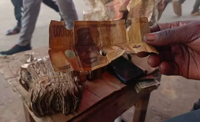 A close-up of perforated notes, which are rejected in Bukavu, Democratic Republic of the Congo, Friday, Aug 29, 2025. (AP Photo)