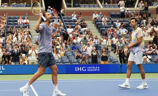 Horacio Zeballos, of Argentina, left, and Marcel Granollers, of Spain, react after defeating Neal Skupski, of Great Britain, and Joe Salisbury, of Great Britain, in the men's doubles final of the U.S. Open tennis championships, Saturday, Sept. 6, 2025, in New York. (AP Photo/Yuki Iwamura)