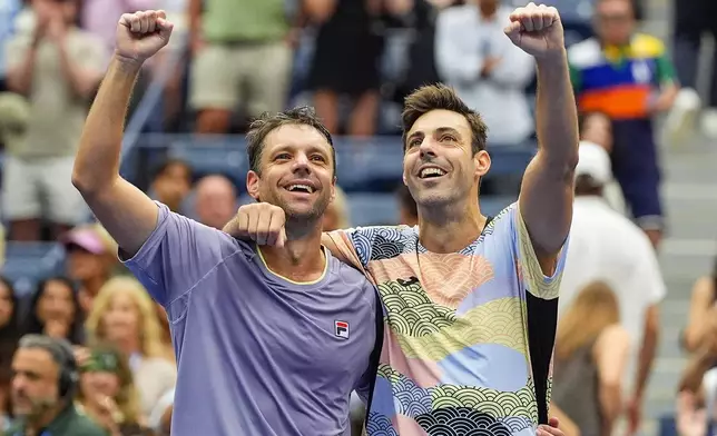 Horacio Zeballos, of Argentina, left, and Marcel Granollers, of Spain, react after defeating Neal Skupski, of Great Britain, and Joe Salisbury, of Great Britain, in the men's doubles final of the U.S. Open tennis championships, Saturday, Sept. 6, 2025, in New York. (AP Photo/Yuki Iwamura)