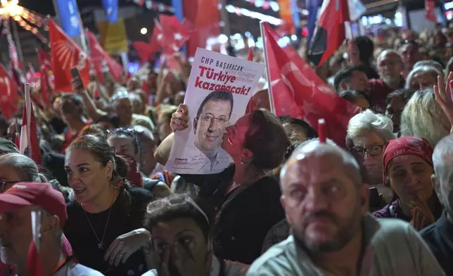 A supporter of Turkey's main opposition Republican People's Party or (CHP) kisses a image of former Istanbul Mayor Ekrem İmamoglu during a party rally, in Istanbul, Turkey, Wednesday, Sept. 10, 2025. (AP Photo/Francisco Seco)
