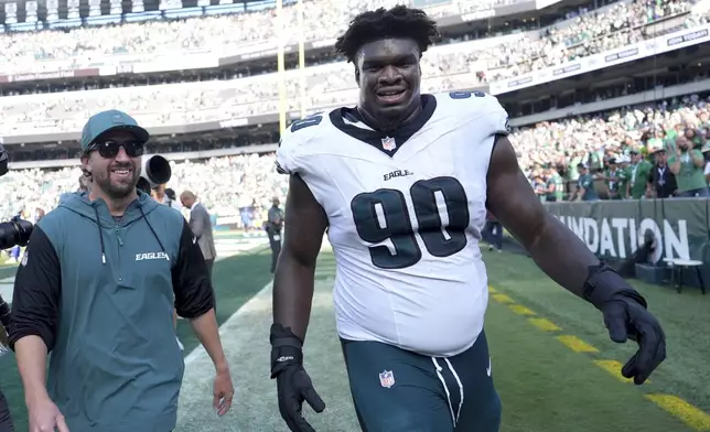 Philadelphia Eagles defensive tackle Jordan Davis (90) celebrates after blocking a field goal attempt and running it back for a touchdown as time expired in an NFL football game against the Los Angeles Rams Sunday, Sept. 21, 2025, in Philadelphia. (AP Photo/Matt Slocum)