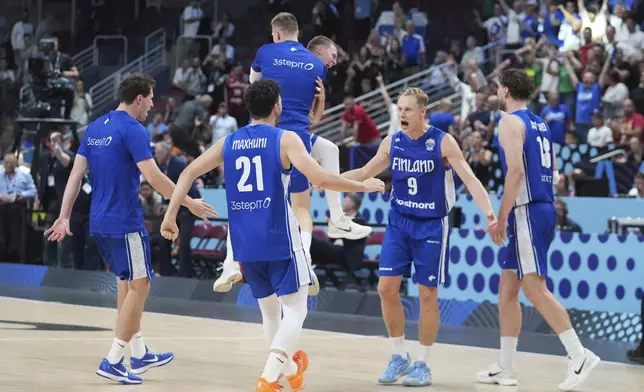 Finland players celebrate their victory after the Eurobasket, European Basketball Championship round of 16 match between Serbia and Finland at the Riga Arena in Riga, Latvia, Saturday, Sept. 6, 2025. (AP Photo/Sergei Grits)