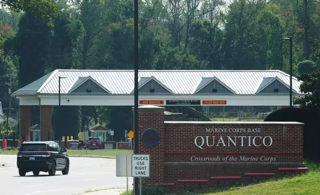 Vehicles drive to the entrance of Marine Corps Base Quantico, Friday Sep. 26, 2025, in Quantico, Va. (AP Photo/Steve Helber)