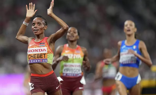 Kenya's Beatrice Chebet celebrates as she wins the gold medal in the women's 5,000 meters final at the World Athletics Championships in Tokyo, Saturday, Sept. 20, 2025. (AP Photo/Petr David Josek)