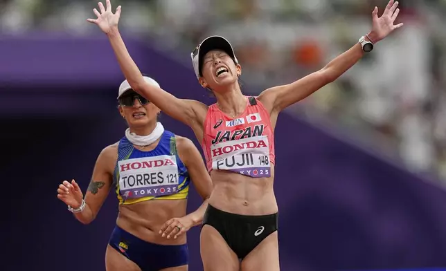Japan's Nanako Fujii beats Ecuador's Paula Milena Torres to the bronze medal in the women's 20 kilometers race walk at the World Athletics Championships in Tokyo, Saturday, Sept. 20, 2025. (AP Photo/Petr David Josek)
