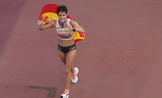 Spain's Maria Perez celebrates after winning the women's 20 kilometers race walk at the World Athletics Championships in Tokyo, Saturday, Sept. 20, 2025. (AP Photo/David J. Phillip)